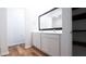 Bathroom featuring dual sinks, a large mirror, and wood-look floors at 29245 Fedora Cir, Brooksville, FL 34602