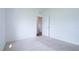 Bright bedroom featuring neutral carpeting and an open door providing access to other rooms in the house at 29245 Fedora Cir, Brooksville, FL 34602