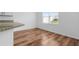 Bright dining area with wood-look floors, a window, and a granite countertop at 29245 Fedora Cir, Brooksville, FL 34602