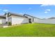 Well-maintained home featuring lush green lawn, attached garage, and modern architectural details at 29245 Fedora Cir, Brooksville, FL 34602