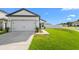 Charming single-Gathering home with a well-manicured lawn, attached garage, and inviting curb appeal at 29245 Fedora Cir, Brooksville, FL 34602