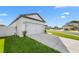 Exterior view of home, highlighting the attached two-car garage and landscaped front yard at 29245 Fedora Cir, Brooksville, FL 34602