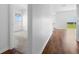 Spacious hallway showing view into bedroom with carpet and sliding glass doors to the exterior at 29245 Fedora Cir, Brooksville, FL 34602