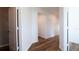 Bright hallway showcasing wood-look floors and neutral walls, creating a seamless transition between rooms in this home at 29245 Fedora Cir, Brooksville, FL 34602
