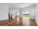 Open-concept living room with wood-look floors and a view of the backyard at 29245 Fedora Cir, Brooksville, FL 34602