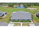 Scenic aerial view of the property highlighting the meticulously maintained landscaping and tranquil pond view at 301 Canton Ct # 77, Sun City Center, FL 33573