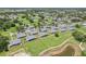 Picturesque community aerial showcases numerous homes, verdant landscapes, and a serene pond, creating a tranquil environment at 301 Canton Ct # 77, Sun City Center, FL 33573