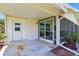 Covered back porch with a screen door and yard view at 301 Canton Ct # 77, Sun City Center, FL 33573