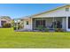 The backyard features a covered patio and green lawn at 301 Canton Ct # 77, Sun City Center, FL 33573