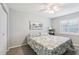 Comfortable bedroom with light grey walls, window and ceiling fan at 301 Canton Ct # 77, Sun City Center, FL 33573