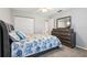 Well-lit bedroom featuring closet, ceiling fan, and dresser at 301 Canton Ct # 77, Sun City Center, FL 33573