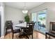 Cozy dining area with wood flooring, decorative chandelier, and sliding glass doors to the outdoor space at 301 Canton Ct # 77, Sun City Center, FL 33573