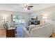 Relaxing living room with plush seating, a ceiling fan, and a view of the backyard at 301 Canton Ct # 77, Sun City Center, FL 33573