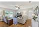 Bright living room with comfortable seating, sliding glass doors and wood-look flooring at 301 Canton Ct # 77, Sun City Center, FL 33573