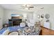 Cozy living room with natural light, ceiling fan, modern furniture, and wood-look flooring at 301 Canton Ct # 77, Sun City Center, FL 33573