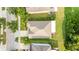 Aerial view of the house, showing the roof, driveway, and surrounding greenery at 3025 Winglewood Cir, Lutz, FL 33558