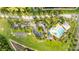 Overhead view of community pool, basketball court, parking, lush green space, and surrounding neighborhood at 3025 Winglewood Cir, Lutz, FL 33558