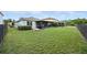 Grassy backyard features an enclosed patio with a nice area for outdoor grilling and entertaining at 3025 Winglewood Cir, Lutz, FL 33558