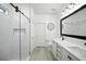 Modern bathroom features a glass-enclosed shower, double vanity, and neutral color palette at 3025 Winglewood Cir, Lutz, FL 33558