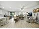Spacious open-concept living room features a large sofa, dining area, and access to a screened patio at 3025 Winglewood Cir, Lutz, FL 33558