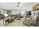 Bright living room showcasing a sectional sofa, modern furniture, and sliding glass doors to the outdoor space at 3025 Winglewood Cir, Lutz, FL 33558