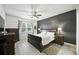 Serene main bedroom with a large bed, dark accent wall, and ample natural light from the window at 3025 Winglewood Cir, Lutz, FL 33558