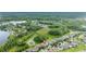 Aerial view of single Gathering homes, lawns, pond, and trees in the background, red pin marking the property at 3025 Winglewood Cir, Lutz, FL 33558
