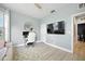 Well-lit office with modern desk, comfortable chair, and mounted TV at 3025 Winglewood Cir, Lutz, FL 33558