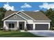 Charming home featuring stone accents, a covered entry, two-car garage, and well-manicured front lawn at 31504 Hayman Loop, Wesley Chapel, FL 33545