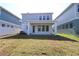 Spacious backyard featuring a covered patio perfect for entertaining, adjacent to neighboring homes at 3275 Guanabana Xing, Wesley Chapel, FL 33543