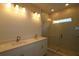 Modern bathroom featuring a double sink vanity, sleek mirrors, and a glass-enclosed shower with tile surround at 3275 Guanabana Xing, Wesley Chapel, FL 33543