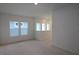 Spacious living room with ample natural light, featuring neutral walls and a minimalist design at 3275 Guanabana Xing, Wesley Chapel, FL 33543
