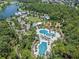 Extensive aerial view showcasing community amenities including pools, a playground, clubhouse, and green spaces at 3603 Tour Trce, Land O Lakes, FL 34638