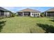 Expansive backyard with lush green lawn, patio area, and privacy fencing at 3603 Tour Trce, Land O Lakes, FL 34638