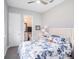 Cozy bedroom with a blue floral comforter, side table, and an ensuite bathroom at 3603 Tour Trce, Land O Lakes, FL 34638