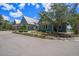 Inviting community clubhouse featuring a stylish exterior with a metal roof and well-maintained landscaping at 3603 Tour Trce, Land O Lakes, FL 34638