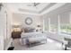 Serene main bedroom featuring tray ceilings, three large windows, and an abundance of natural light at 3603 Tour Trce, Land O Lakes, FL 34638