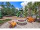 Charming community playground featuring a fun climbing structure, a slide, and comfortable seating around a firepit at 3603 Tour Trce, Land O Lakes, FL 34638