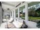 Inviting outdoor porch with comfortable seating and views of the landscaped yard at 3603 Tour Trce, Land O Lakes, FL 34638