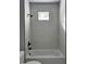 Bathroom showcasing white tiled shower, black hardware, and recessed window at 4200 N 15Th St, Tampa, FL 33610