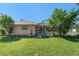 Backyard with lush greenery, trees, and partial view of a screened-in patio at 4355 Odin St, Spring Hill, FL 34608