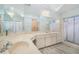 Bright bathroom featuring double vanity, large mirror, and a shower at 4355 Odin St, Spring Hill, FL 34608