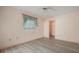 Bedroom with wood-look floors, window, and access to a closet at 4355 Odin St, Spring Hill, FL 34608