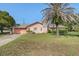 Charming single-story home with a well-maintained lawn and a large palm tree in the front yard at 4355 Odin St, Spring Hill, FL 34608