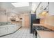 Kitchen features stainless steel refrigerator, white cabinetry, tile floor, and lots of counter space at 4355 Odin St, Spring Hill, FL 34608