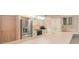 Bright kitchen with stainless steel refrigerator, white cabinets, and breakfast bar at 4355 Odin St, Spring Hill, FL 34608