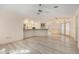 Open living space featuring sleek flooring, breakfast bar, and easy access to outdoor patio at 4355 Odin St, Spring Hill, FL 34608