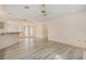 Open living room featuring modern flooring, fan, and natural light from the sliding glass doors at 4355 Odin St, Spring Hill, FL 34608