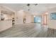Open-concept living area with light-colored walls and floors, chandelier lighting, and kitchen view at 4355 Odin St, Spring Hill, FL 34608