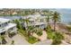 Beautiful waterfront property featuring a custom home, mature trees, and a private dock at 442 Midway Is, Clearwater Beach, FL 33767